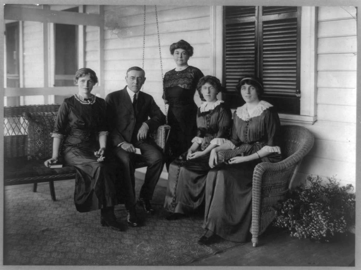 Woodrow Wilson is photographed with his daughters on their porch swing